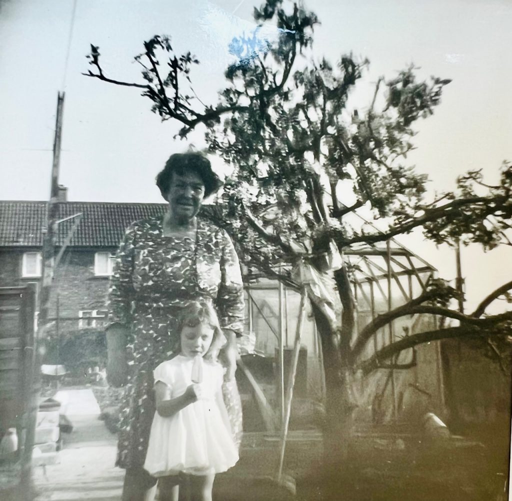 1960s Childhood photograph. Grandma and Grandaughter eating ice cream in the garden. England 1966.